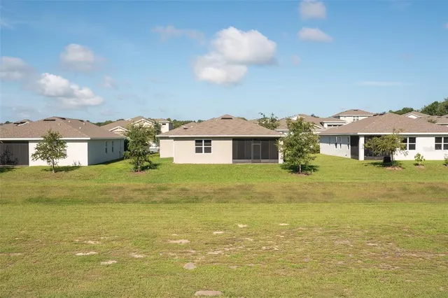 a front view of a house with a big yard