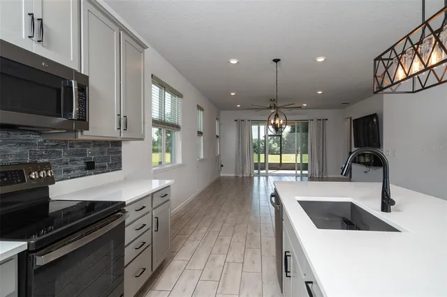 a kitchen with a sink stove and microwave