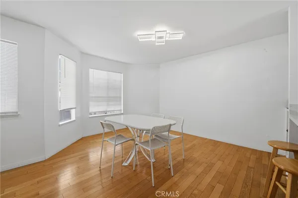a view of empty room with wooden floor and fireplace