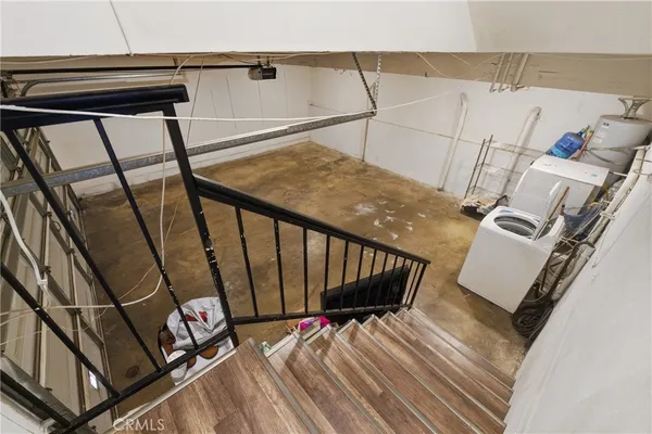 a view of a livingroom with stairs and a couch