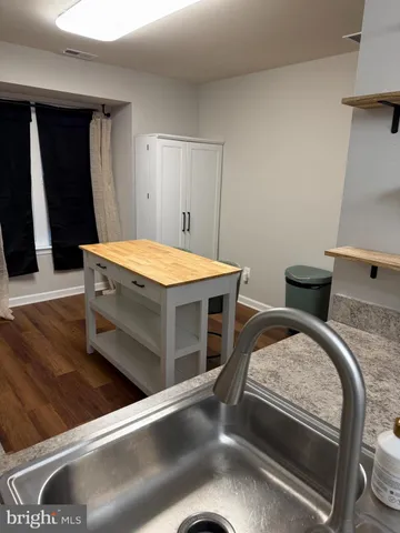a kitchen with a sink and a refrigerator