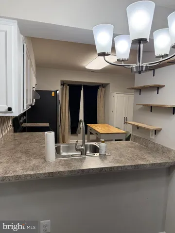 a view of a room with wooden floor and chair