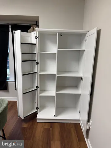 a view of walk in closet with empty racks