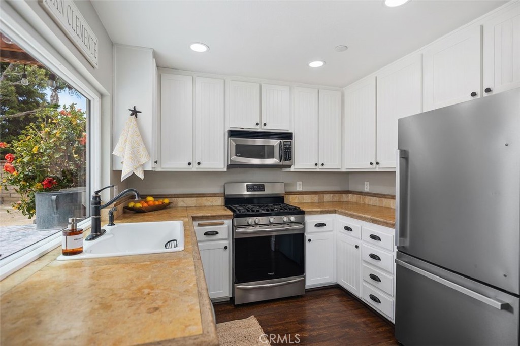 2818 Via Blanco San Clemente, CA 92673 - Photo 17 of 45 a kitchen with granite countertop a refrigerator stove and sink