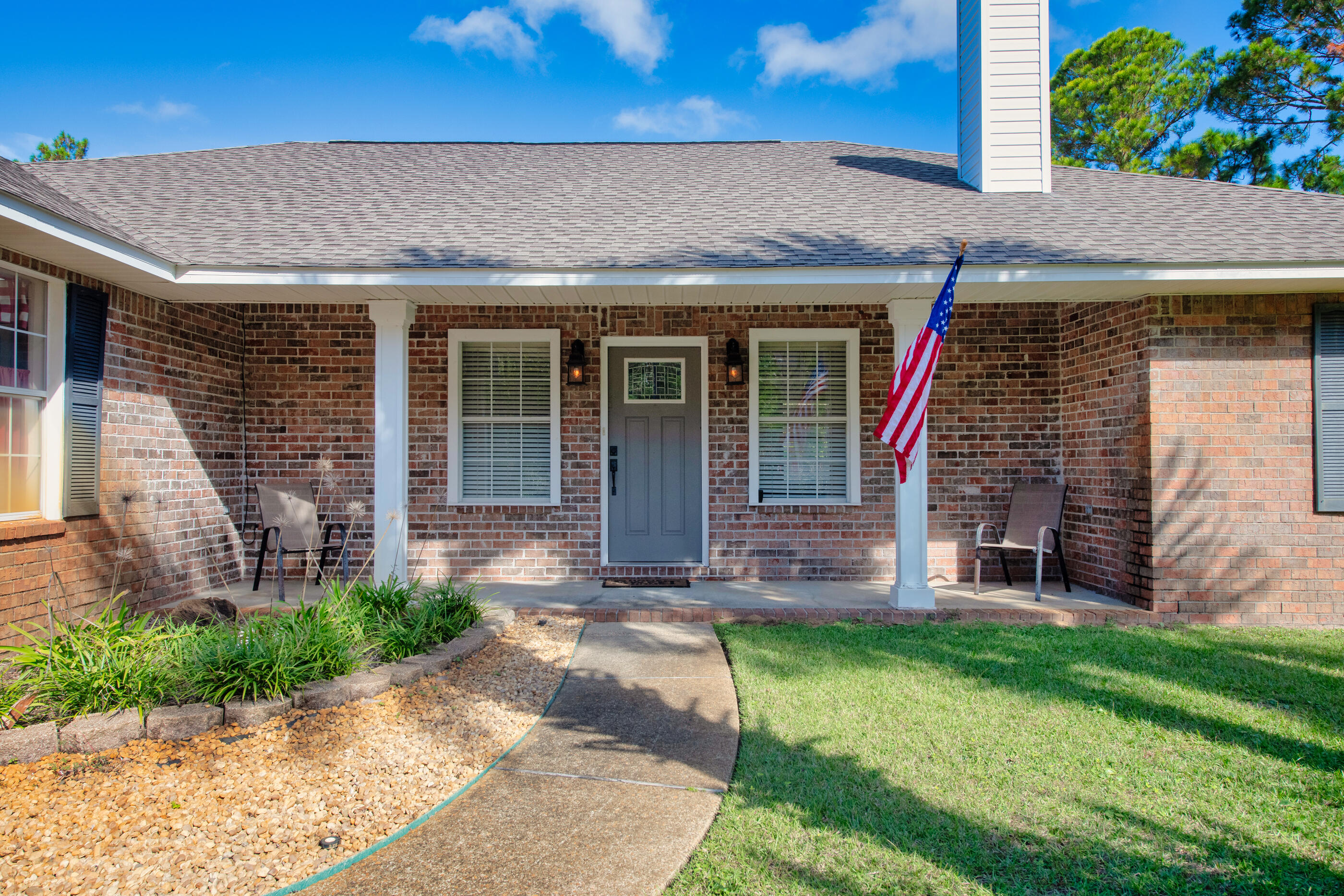 6664 Bellingham Street Navarre, FL 32566 - Photo 1 of 28 front view of a house with a yard