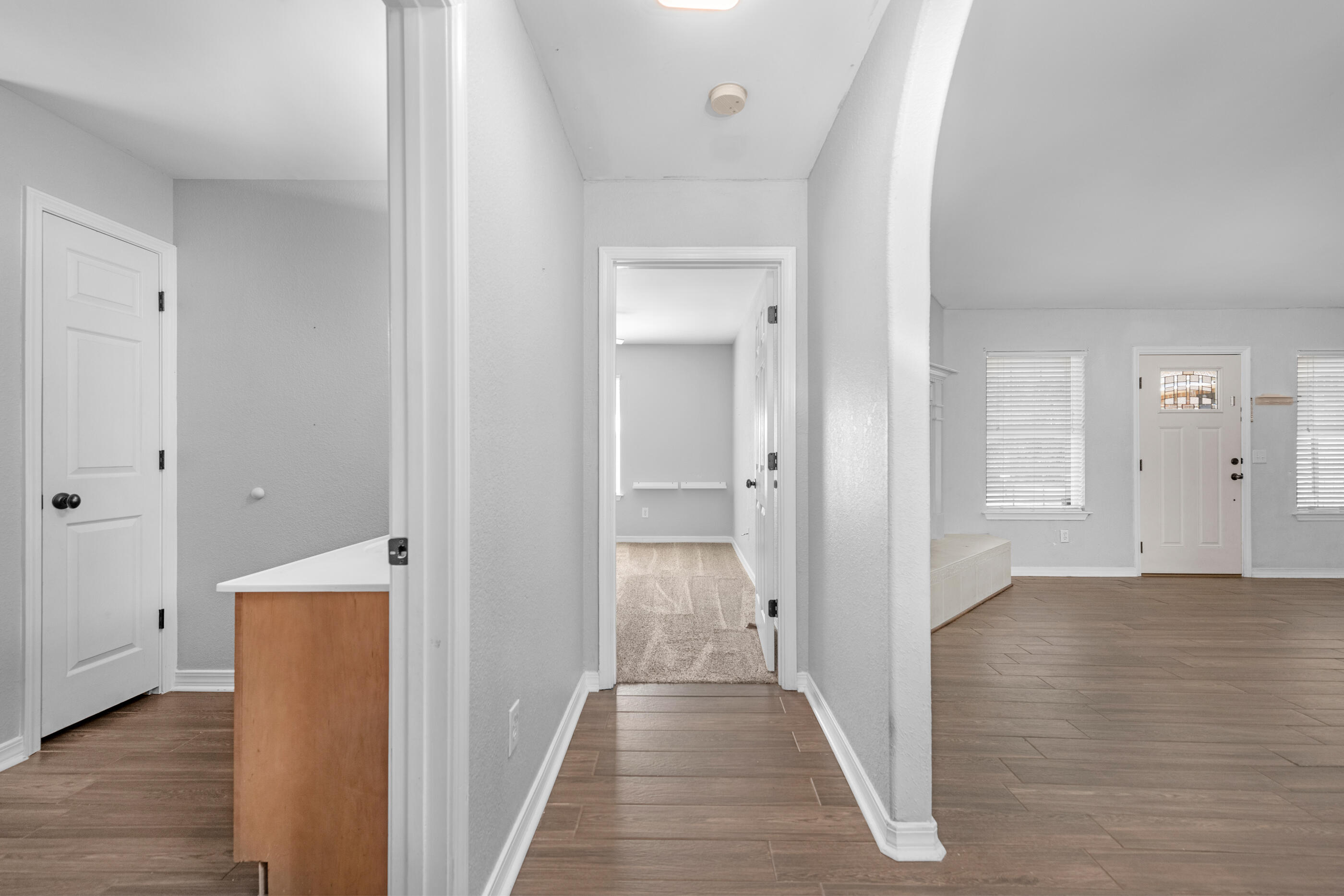 6664 Bellingham Street Navarre, FL 32566 - Photo 19 of 28 a view of a hallway with wooden floor