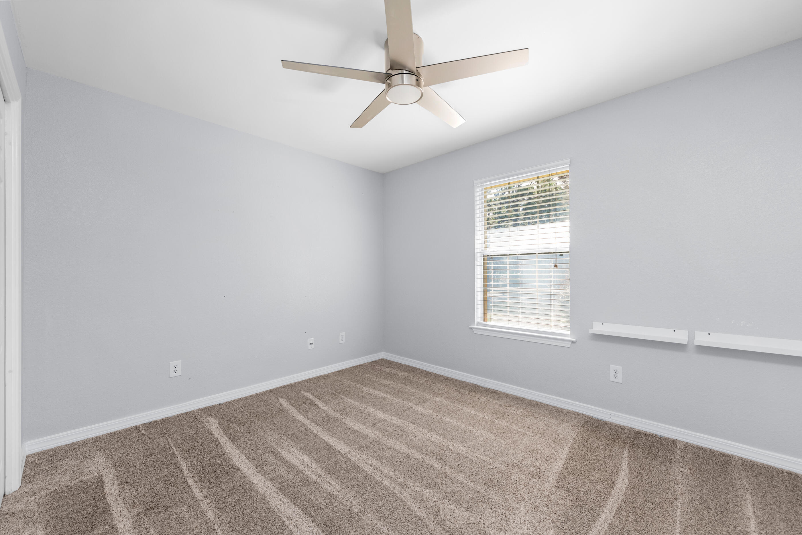 6664 Bellingham Street Navarre, FL 32566 - Photo 20 of 28 an empty room with a window and a fan