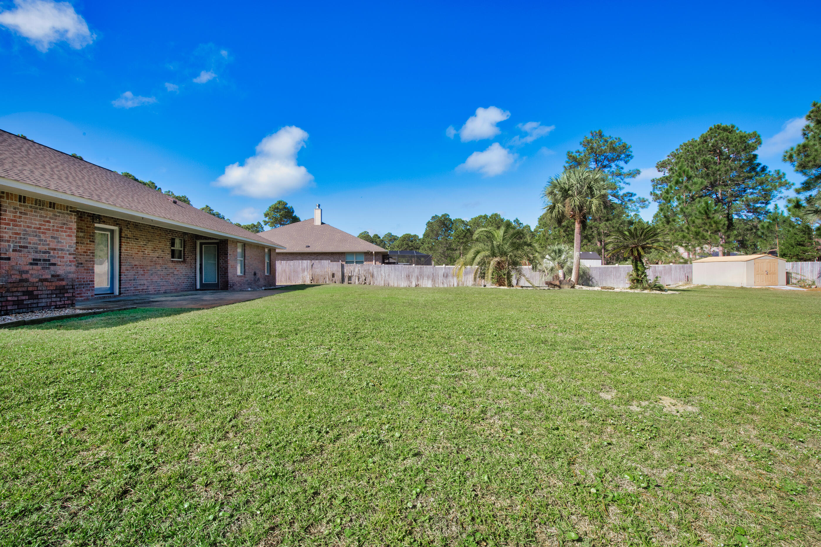 6664 Bellingham Street Navarre, FL 32566 - Photo 24 of 28 a view of a house with a big yard