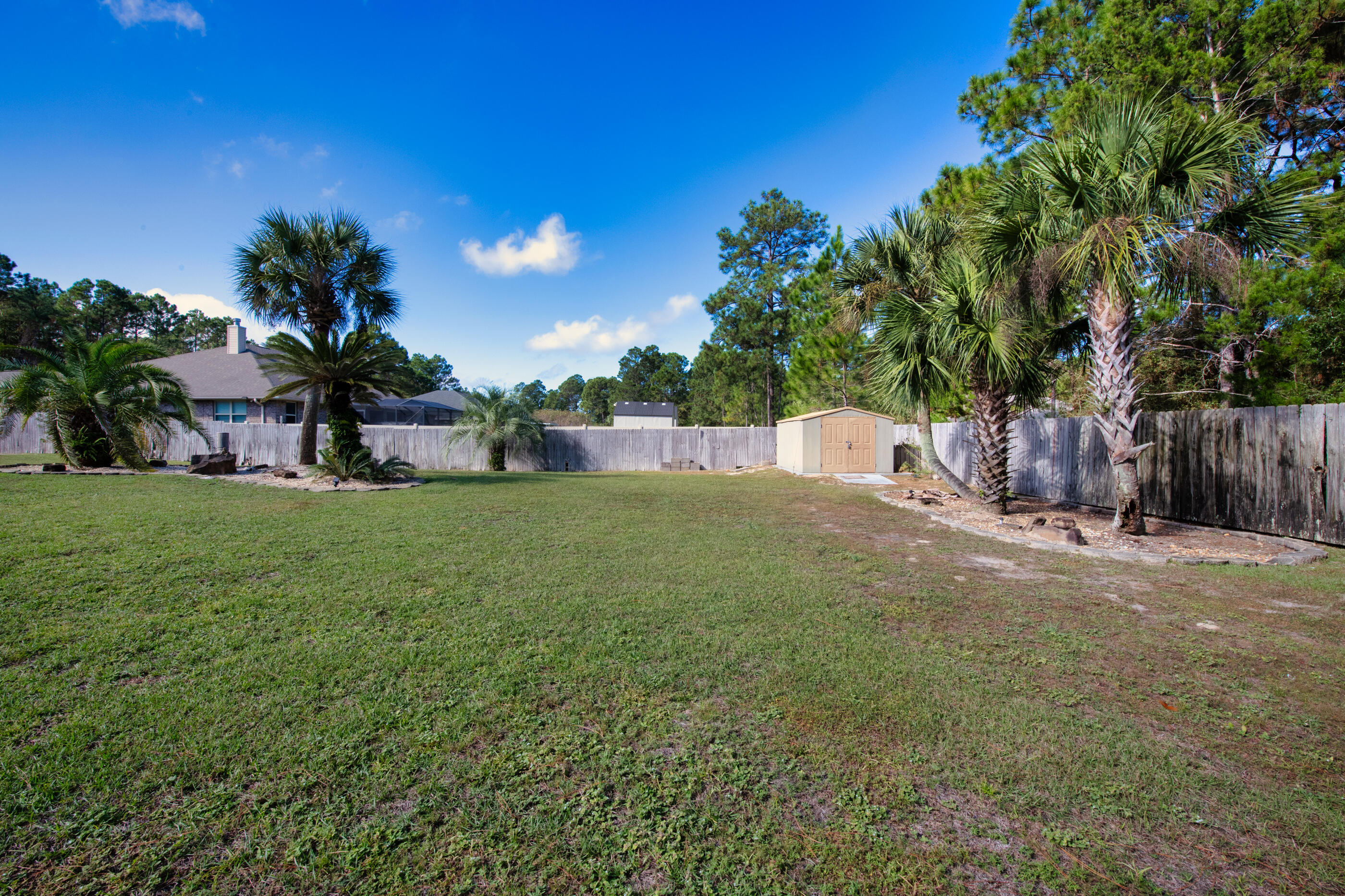 6664 Bellingham Street Navarre, FL 32566 - Photo 26 of 28 a view of a backyard with a tree
