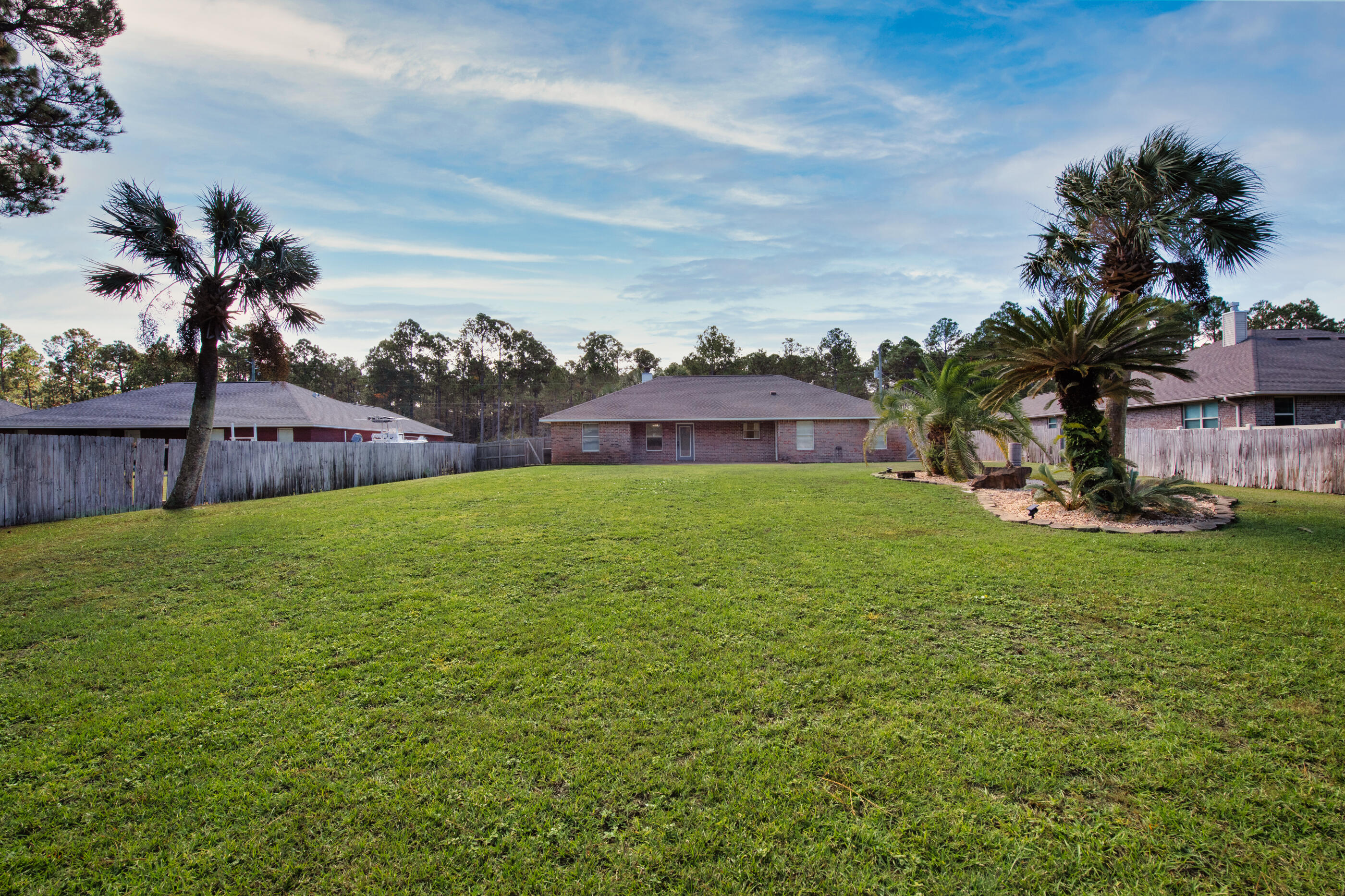 6664 Bellingham Street Navarre, FL 32566 - Photo 27 of 28 a view of a house with a yard