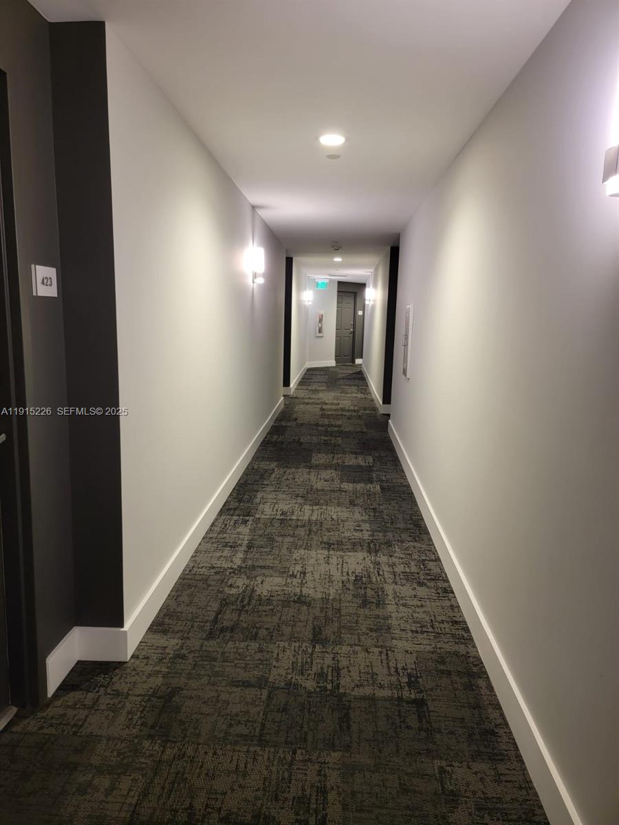 140 South Dixie Highway, Unit 423 Hollywood, FL 33020 - Photo 11 of 32 wooden floor with a hallway