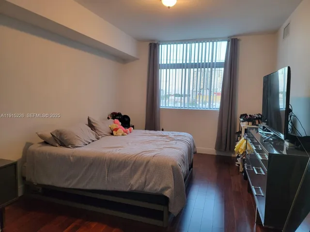 a view of walk in closet with clothes