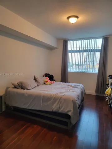a view of a small space with wooden floor and a window