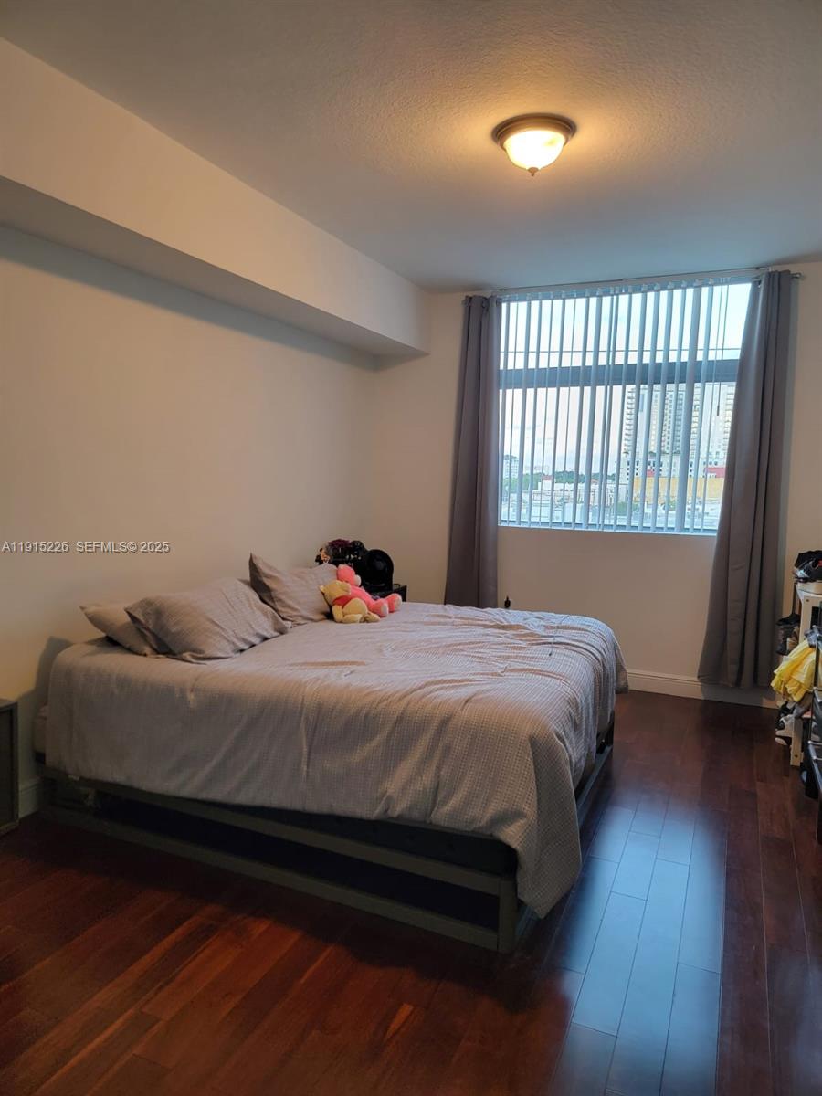 140 South Dixie Highway, Unit 423 Hollywood, FL 33020 - Photo 22 of 32 a bedroom with a bed and wooden floor