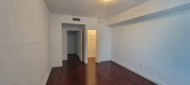 a white toilet and tub sitting next to a bathroom sink