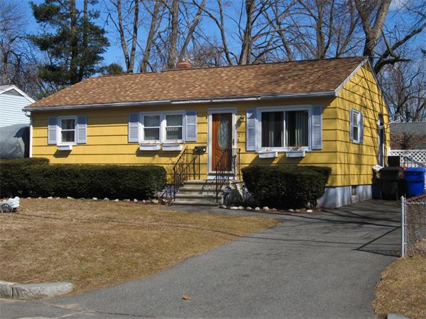 27 Alice Street Springfield, MA 01109 - Photo 1 of 8 a front view of a house with yard and trees in the background