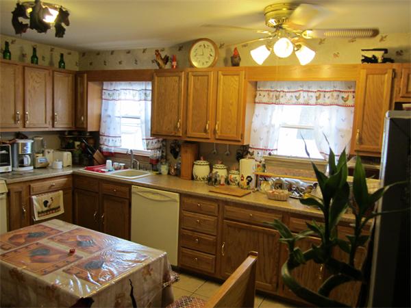 27 Alice Street Springfield, MA 01109 - Photo 5 of 8 a kitchen with a sink a stove cabinets and a window