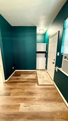 a view of a room with wooden floor and ceiling fan