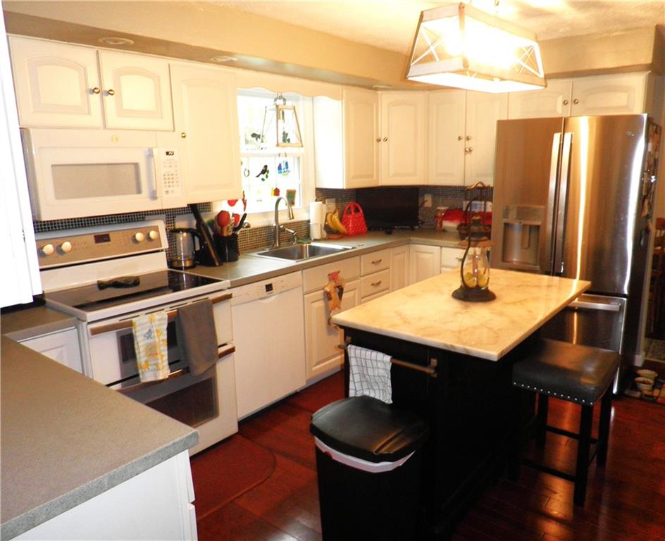 17 Hones Road Export, PA 15632 - Photo 8 of 16 a kitchen with stainless steel appliances kitchen island granite countertop a sink a stove and refrigerator