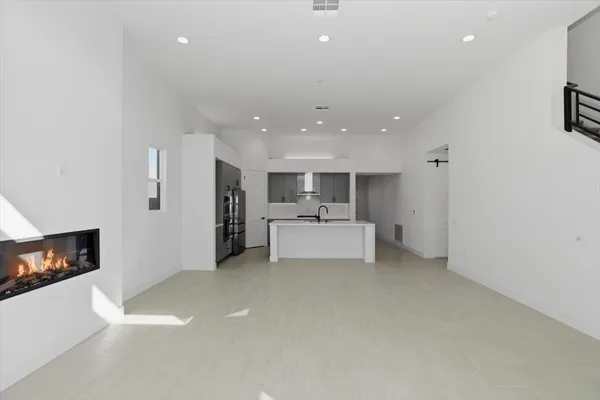 a view of a kitchen with a sink and a refrigerator