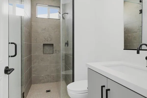 a bathroom with a sink toilet and shower