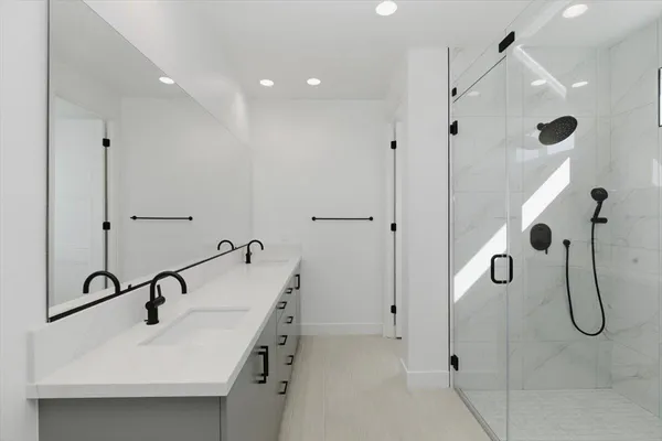 a bathroom with a sink a mirror and shower