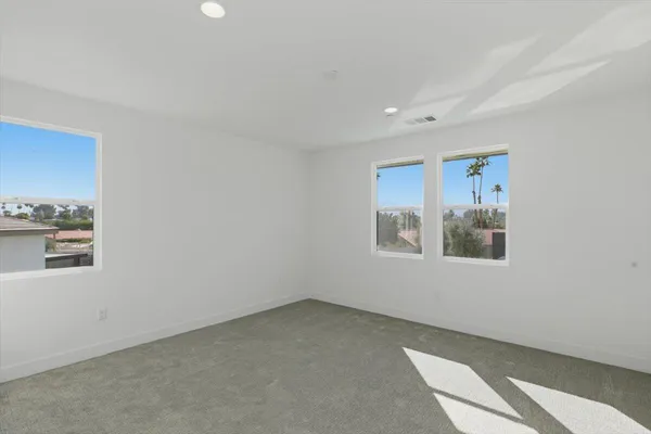 a view of a big room with window and workspace