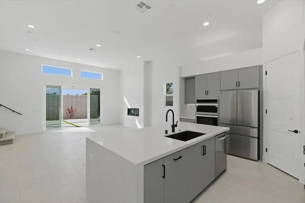 a kitchen with refrigerator and cabinets