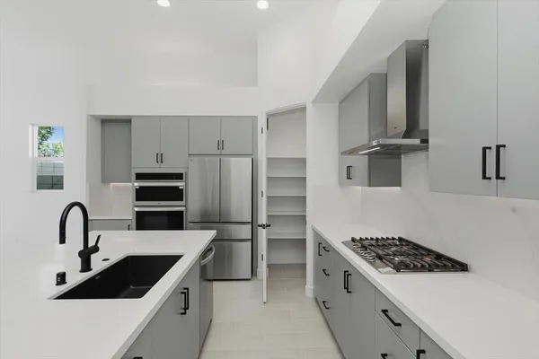a kitchen with stainless steel appliances kitchen island a sink stove and refrigerator