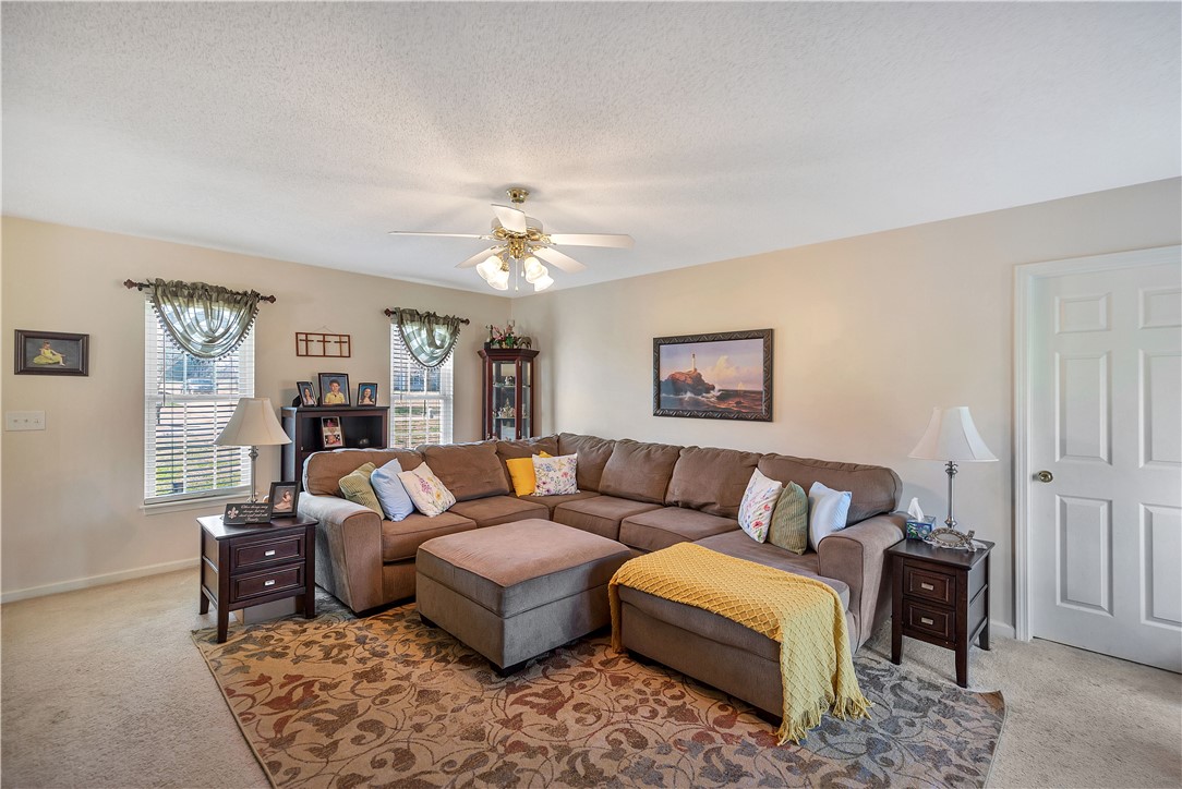108 Grindstone Way Anderson, SC 29625 - Photo 20 of 30 This inviting living room offers a comfortable and spacious setting for relaxation.