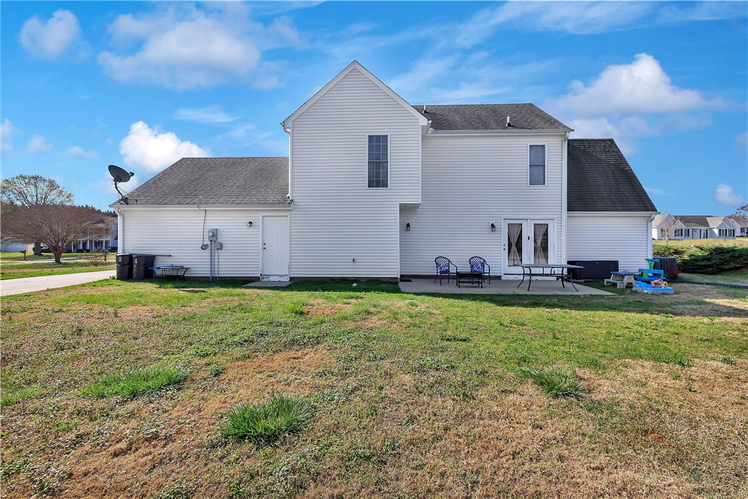 108 Grindstone Way Anderson, SC 29625 - Photo 6 of 30 The rear exterior features a patio area and a well-maintained lawn, perfect for outdoor activities.
