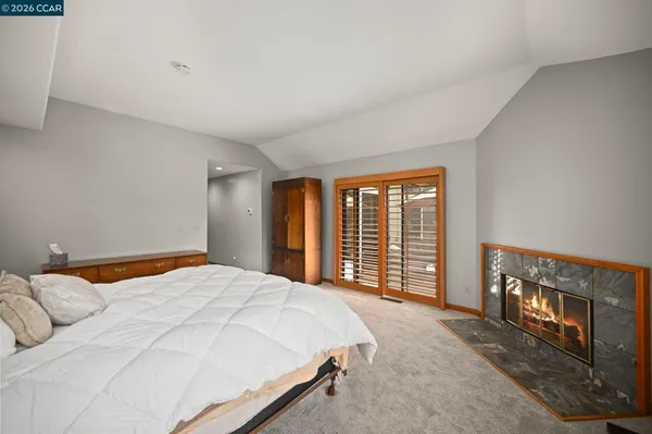 a bedroom with a large bed and a large window