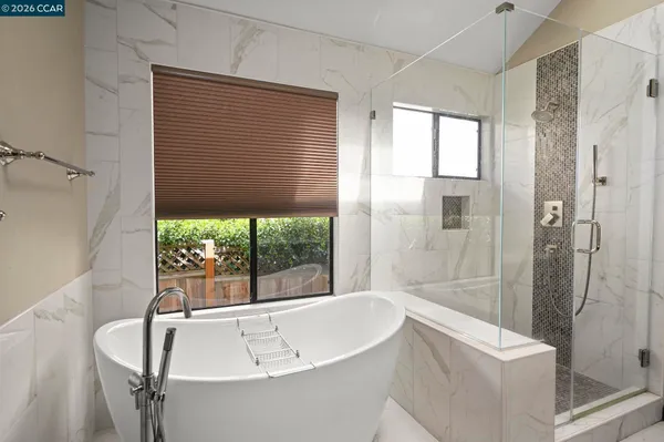 a bathroom with a bathtub and shower