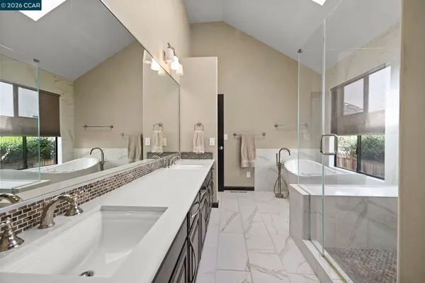 a large white kitchen with a large window