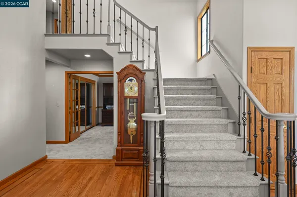 a view of entryway and hall with wooden floor
