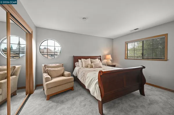 a bed room with a bed and a chair