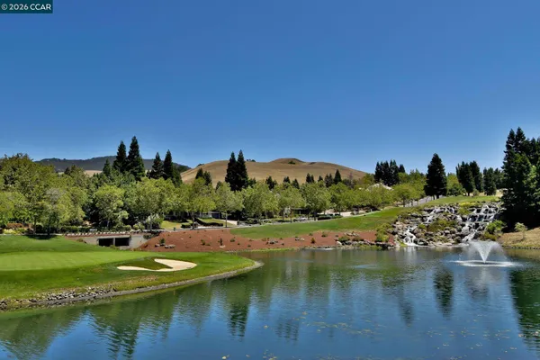 a view of a table and chairs in backyard