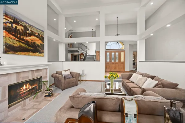 a living room with furniture fireplace and flat screen tv