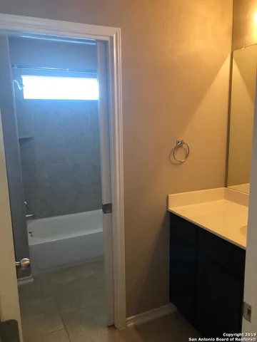 an empty room with closet and a window