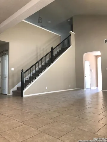 a view of kitchen with stainless steel appliances granite countertop a refrigerator and a stove top oven