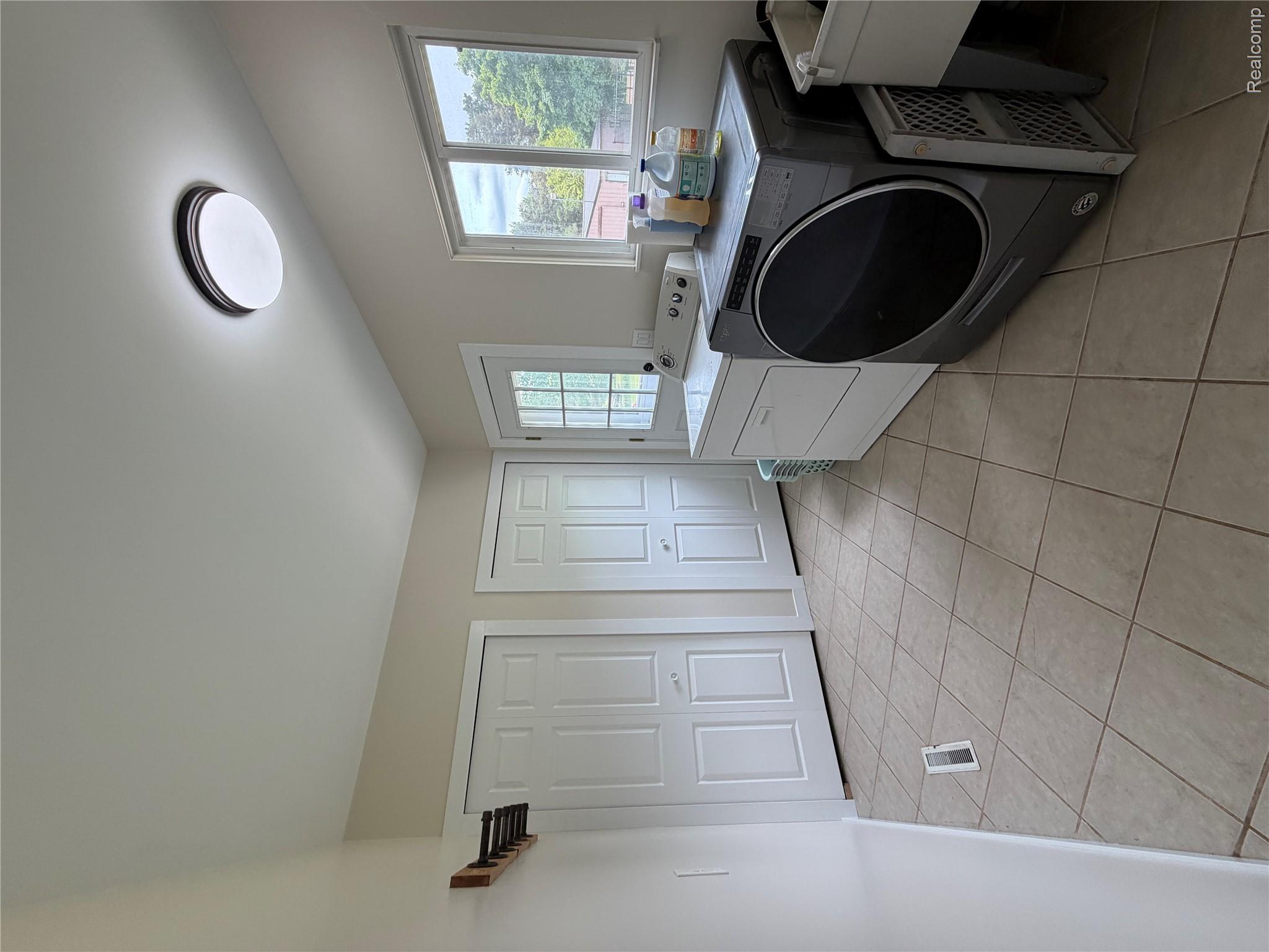 2712 North Branch Road North Branch, MI 48461 - Photo 16 of 37 Laundry area with independent washer and dryer and light tile patterned floors