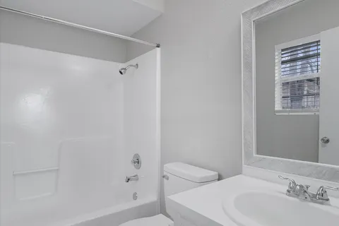 a bathroom with a toilet a sink and a bathtub
