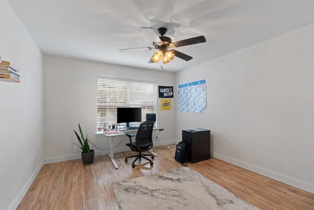 a workspace with wooden floor and a window