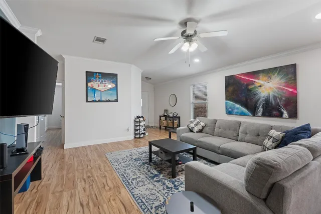 a living room with furniture and a flat screen tv