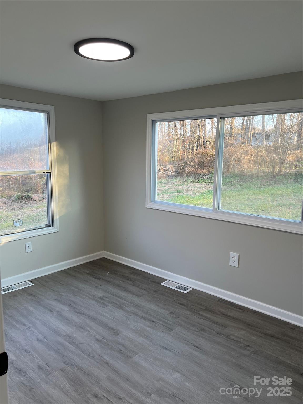 1879 Gaynell Street Conover, NC 28613 - Photo 12 of 20 a view of an empty room with wooden floor and a window