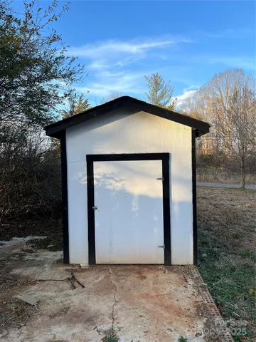 a view of a wooden house with a yard