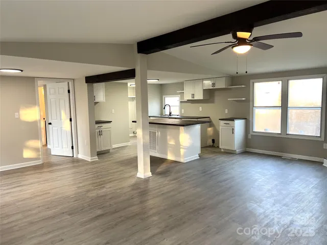 a view of a kitchen with a stove cabinets and wooden floor