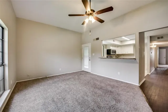 a view of a kitchen with a sink and a refrigerator