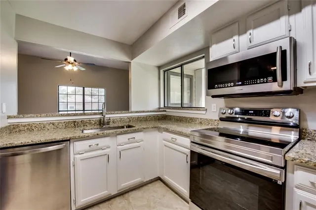 a kitchen with a stove microwave and sink