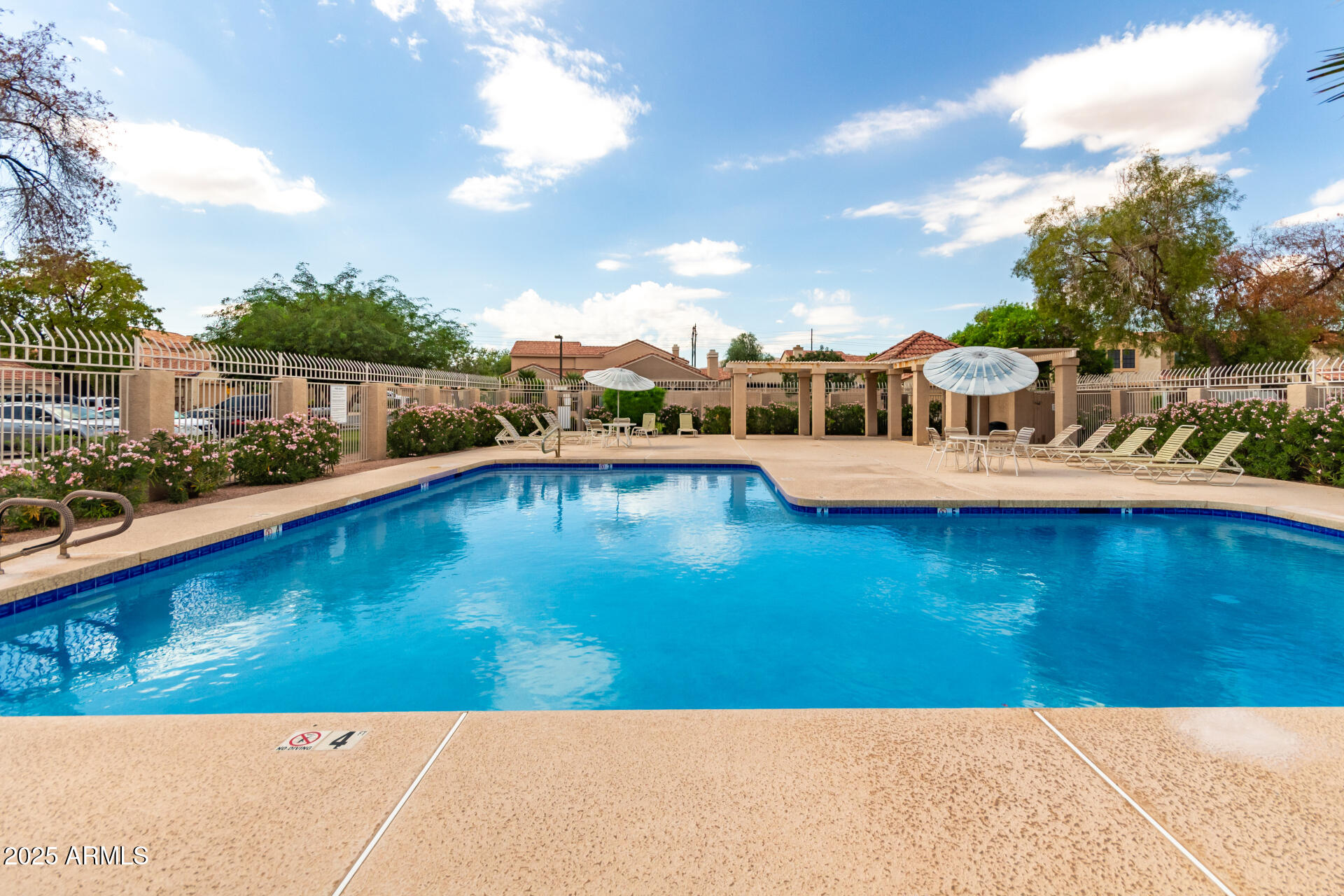 4214 East Agave Road Phoenix, AZ 85044 - Photo 44 of 67 a view of a swimming pool with an ocean and houses